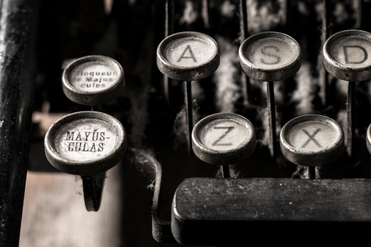 Home Detailed close-up of vintage typewriter keys showing dust and age.